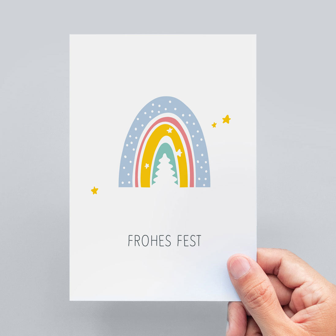 Auf der abgebildeten Weihnachtspostkarte steht "Frohes Fest" unter einem Regenbogen