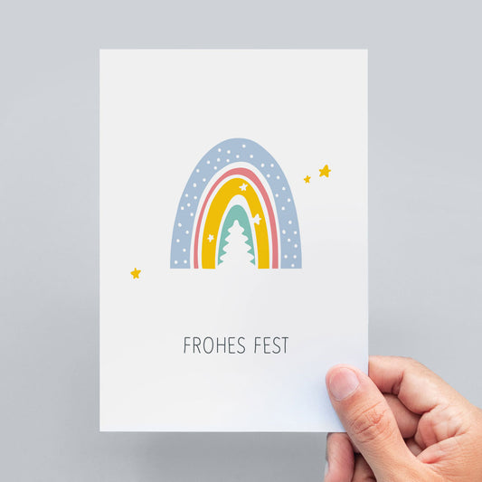 Auf der abgebildeten Weihnachtspostkarte steht "Frohes Fest" unter einem Regenbogen